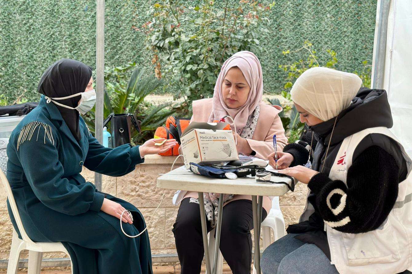 An MSF doctor examines a patient at a mobile clinic in Hebron, Palestine.