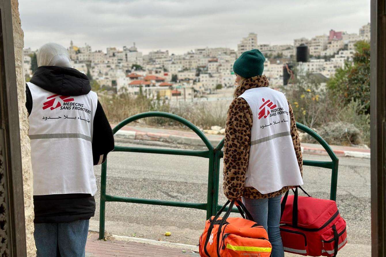 MSF staff walk to set up a mobile clinic in Hebron, Palestine.